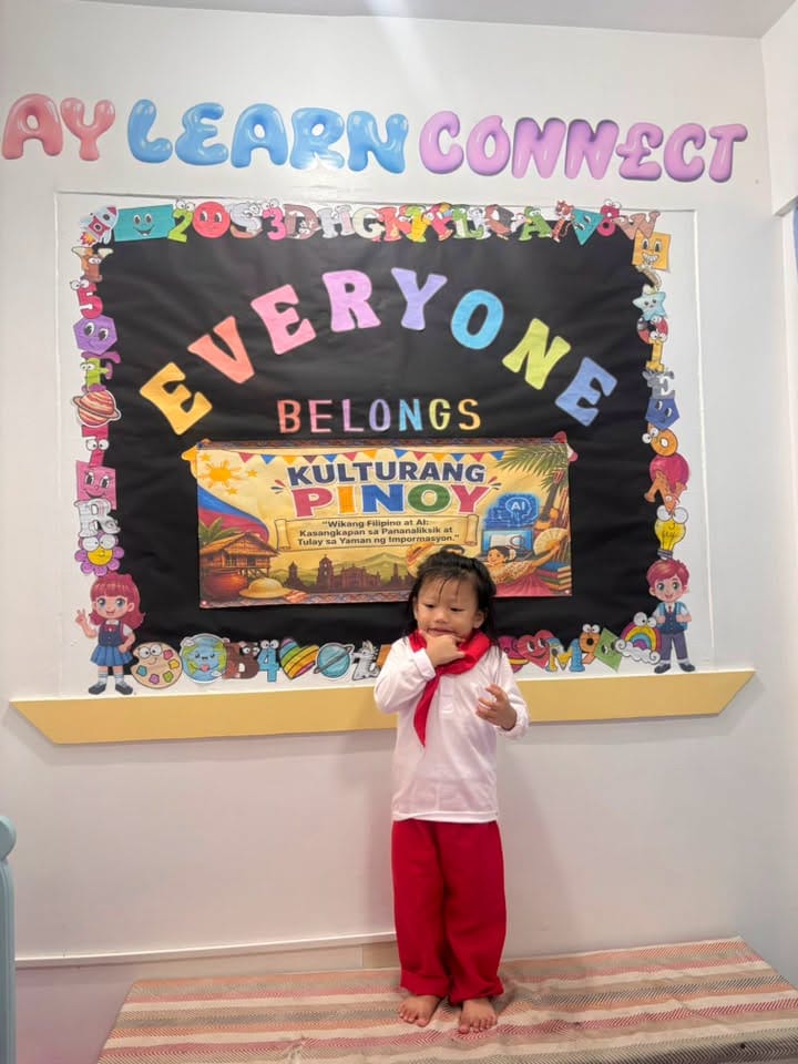 A child in the playroom under the PLAY LEARN CONNECT wall